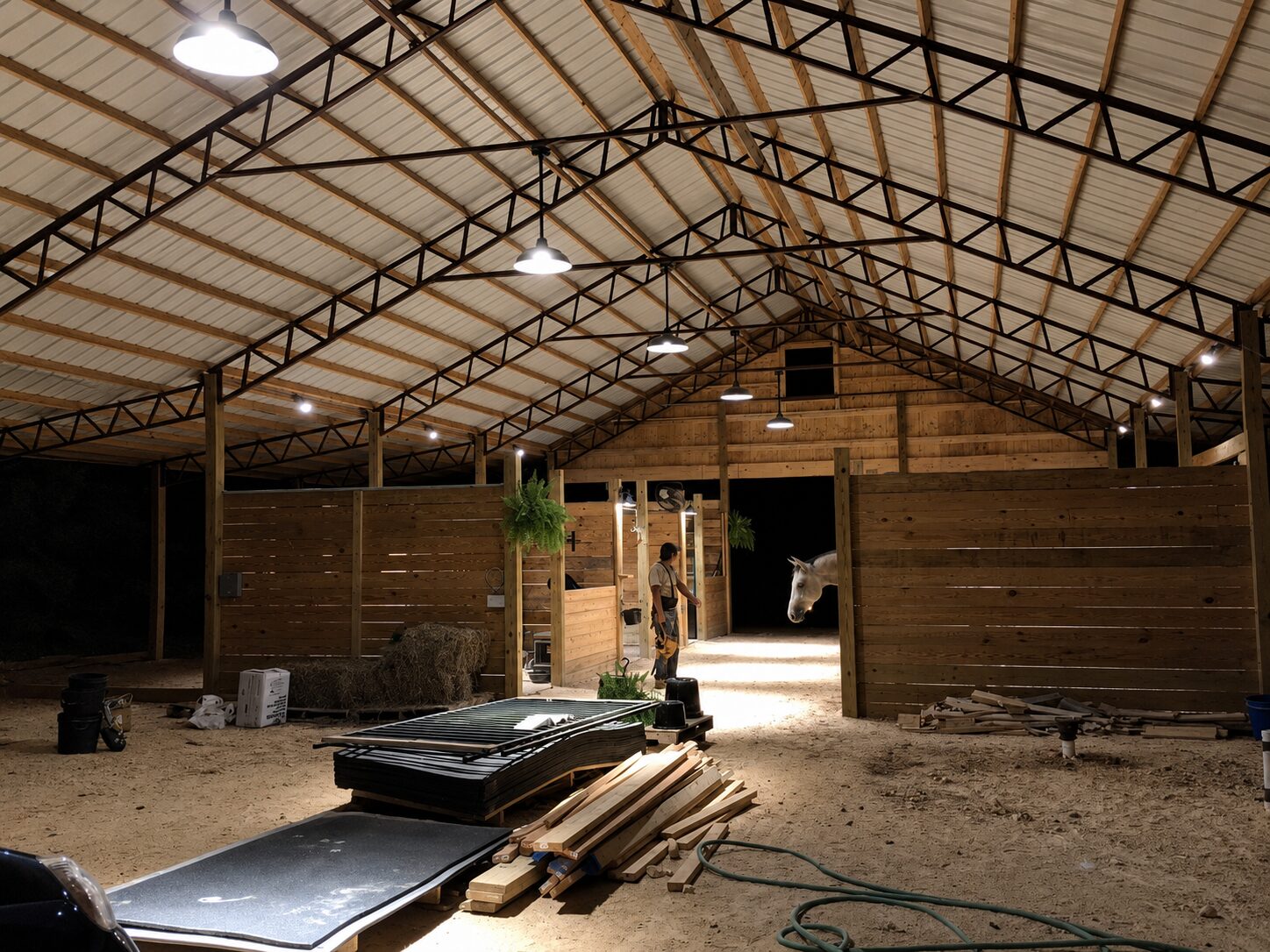 Interior of a pole barn showing steel trusses and purlins